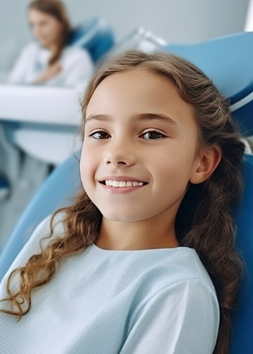 Young girl smiling in dental chair