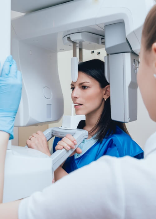 Dental patient having a cone beam C T scan taken of her mouth and jaw