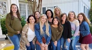 Dental team in casual clothing smiling outdoors together
