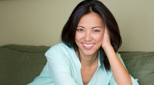 Smiling woman in mint green blouse